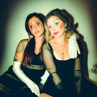 two women dressed as clowns posing for a photo